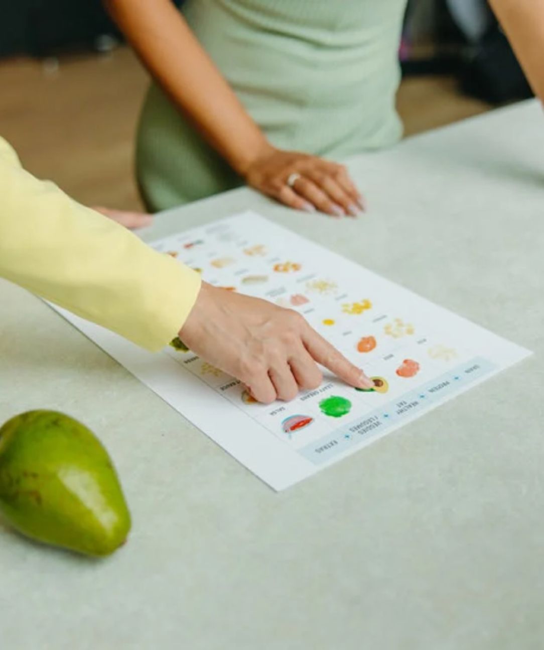 A health coach pointing to a nutrition plan.